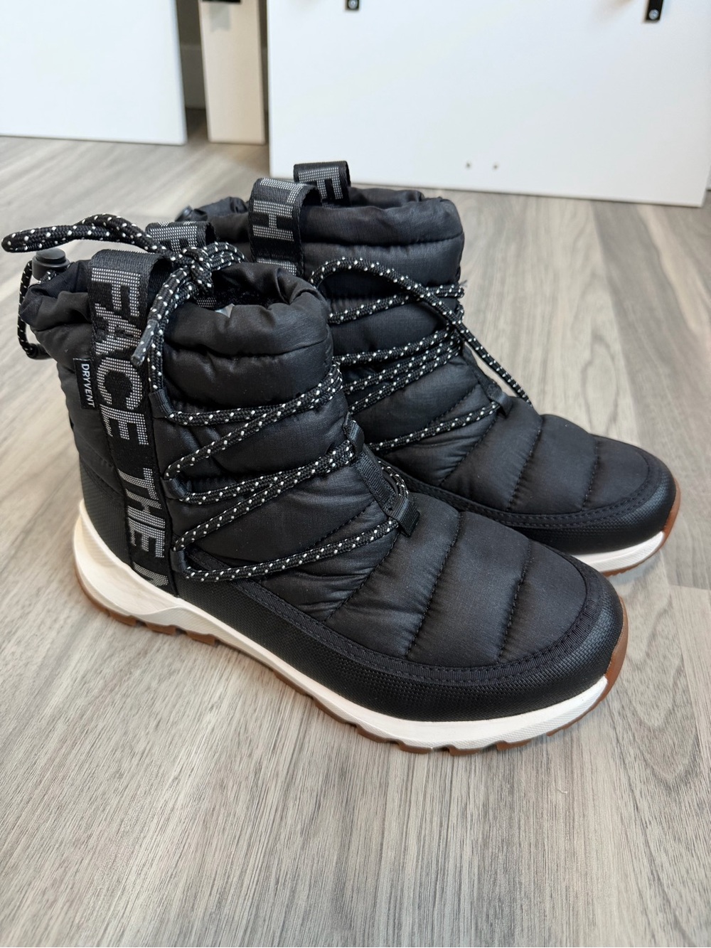 The North Face Black Quilted Girls' Insulated Snow Boots with White Midsole